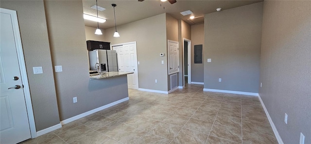 empty room featuring visible vents, a ceiling fan, a sink, electric panel, and baseboards