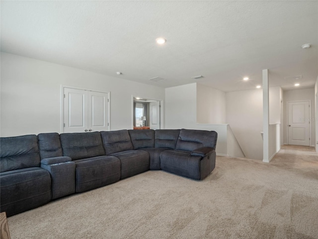 living area with a textured ceiling, carpet, visible vents, and recessed lighting