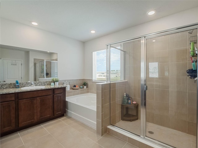 full bathroom featuring a garden tub, recessed lighting, vanity, a shower stall, and tile patterned floors