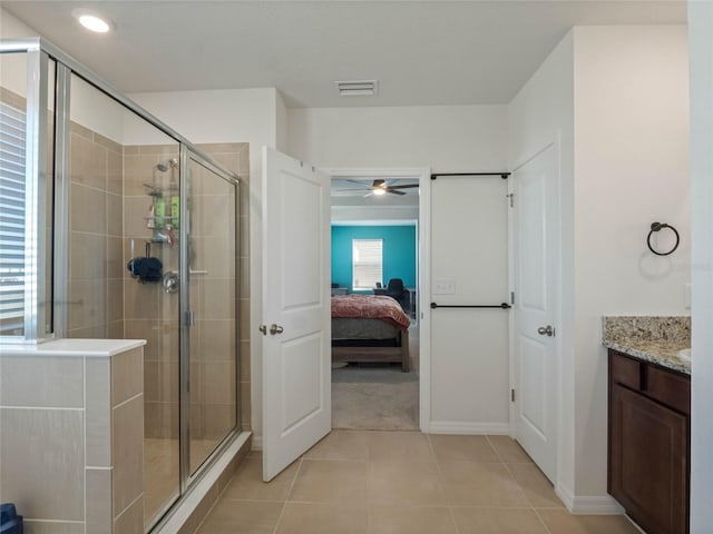 ensuite bathroom with ensuite bathroom, tile patterned flooring, visible vents, vanity, and a shower stall