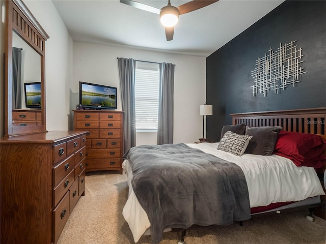 bedroom with light carpet and ceiling fan