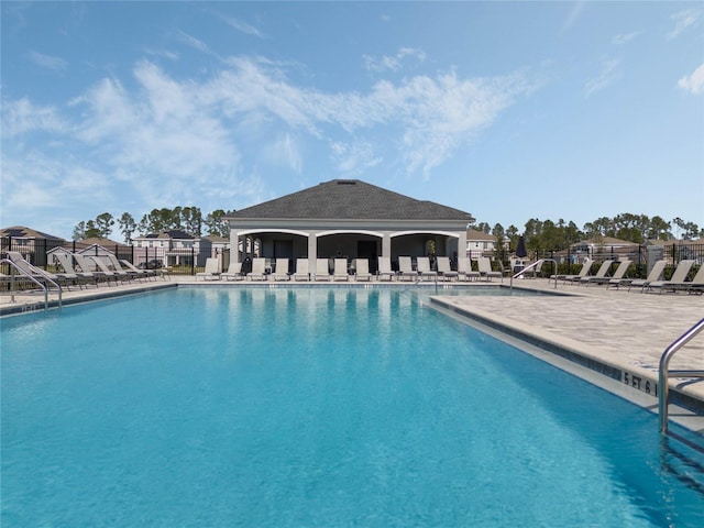 pool featuring a patio area and fence