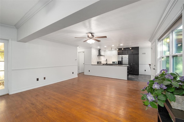 unfurnished living room with ornamental molding, dark wood finished floors, and plenty of natural light