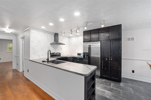 kitchen featuring a peninsula, visible vents, electric stove, wall chimney range hood, and stainless steel refrigerator with ice dispenser