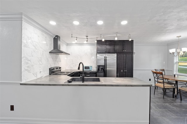 kitchen featuring stainless steel appliances, wall chimney range hood, a sink, and light countertops