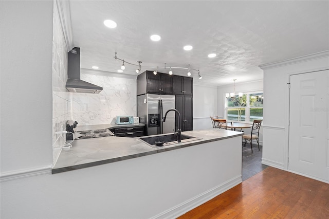 kitchen featuring white microwave, dark wood-type flooring, a sink, stainless steel fridge, and extractor fan