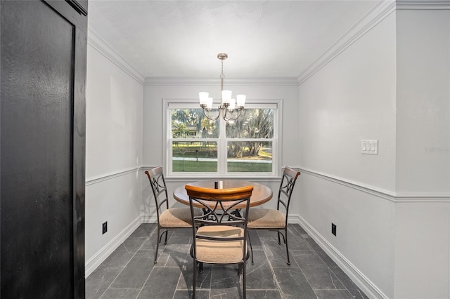 dining area with a chandelier, baseboards, and crown molding