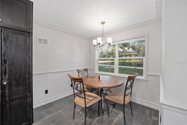 dining room featuring a chandelier, baseboards, visible vents, and crown molding