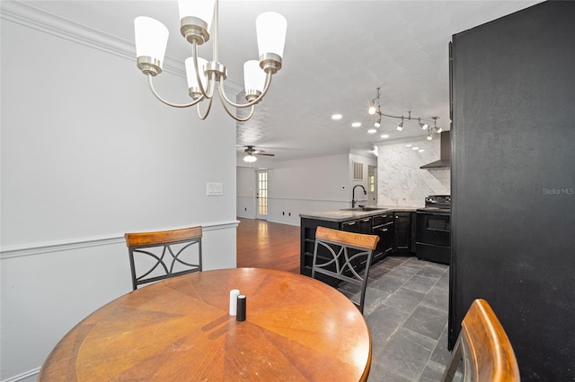 dining space with ornamental molding and ceiling fan with notable chandelier