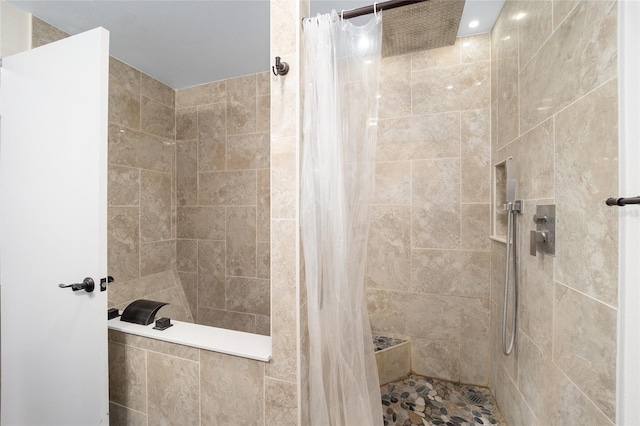 full bathroom with tiled shower