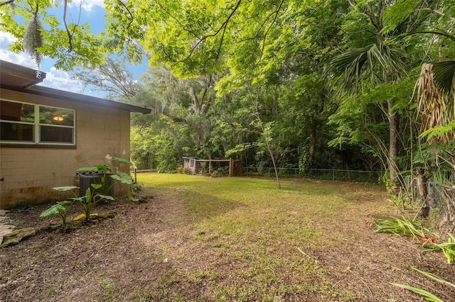 view of yard featuring fence and central air condition unit