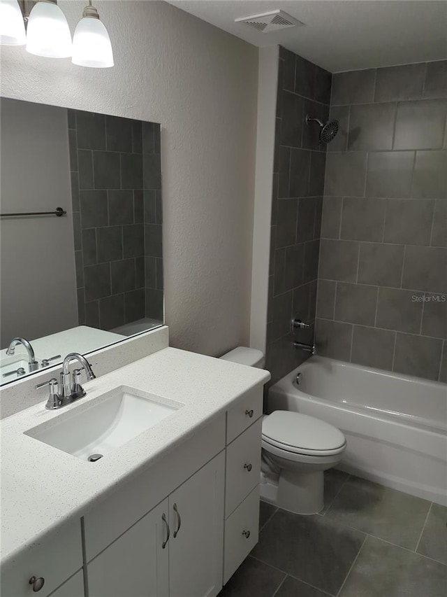 full bathroom featuring tile patterned flooring, toilet, vanity, bathing tub / shower combination, and visible vents