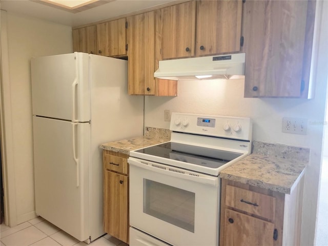 kitchen featuring white appliances, brown cabinets, light countertops, under cabinet range hood, and light tile patterned flooring