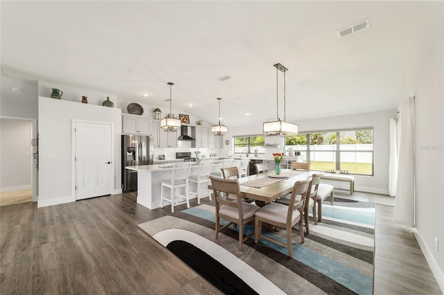 dining room featuring baseboards, visible vents, dark wood-type flooring, vaulted ceiling, and recessed lighting