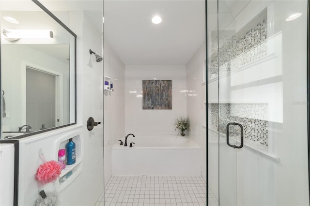 full bathroom featuring a stall shower, tile patterned flooring, and a garden tub