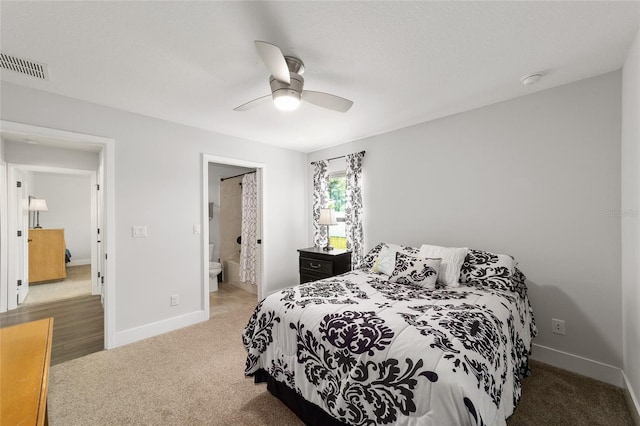 bedroom with ceiling fan, connected bathroom, visible vents, baseboards, and carpet