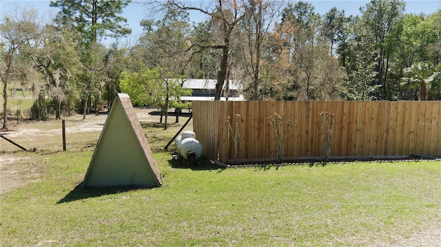 view of home's community featuring a yard and fence