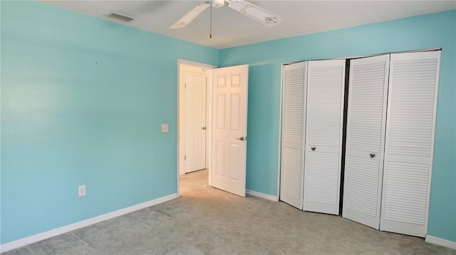 unfurnished bedroom featuring carpet flooring, a closet, visible vents, and baseboards