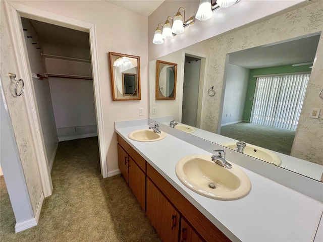 bathroom with a sink and wallpapered walls