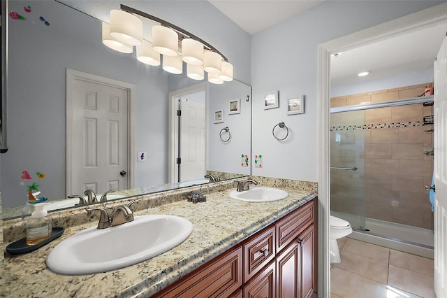 bathroom featuring a sink, a shower stall, and tile patterned floors