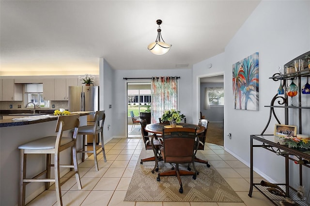 dining area featuring light tile patterned floors, visible vents, and baseboards