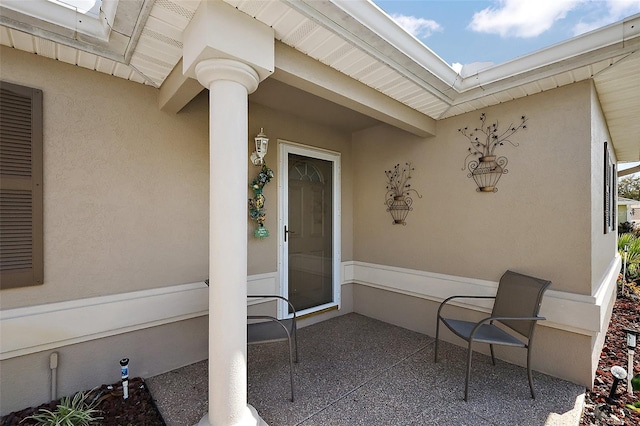 doorway to property with a patio and stucco siding