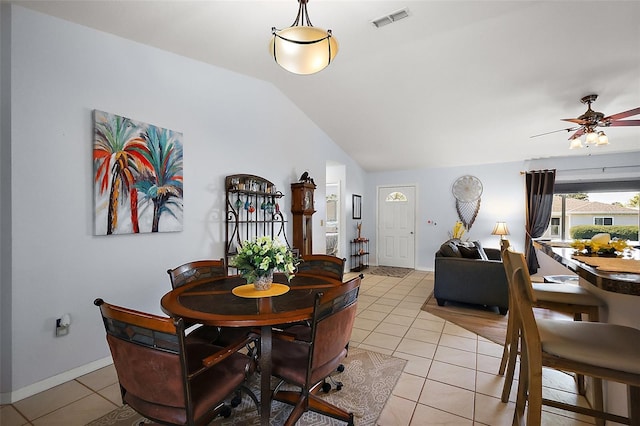 dining room featuring a ceiling fan, lofted ceiling, visible vents, and light tile patterned flooring