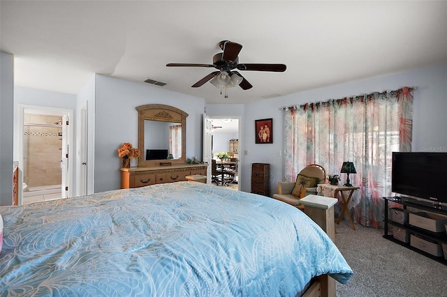 carpeted bedroom featuring ceiling fan, ensuite bath, and visible vents