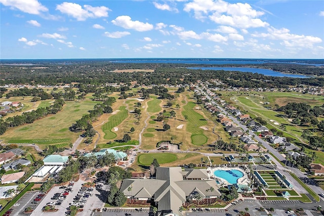 birds eye view of property with a water view and golf course view