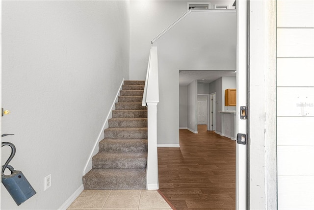 stairway featuring baseboards and wood finished floors