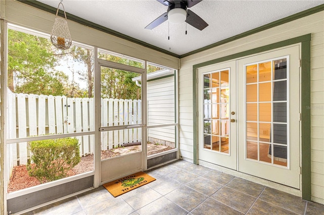 sunroom / solarium with a ceiling fan, french doors, and a healthy amount of sunlight