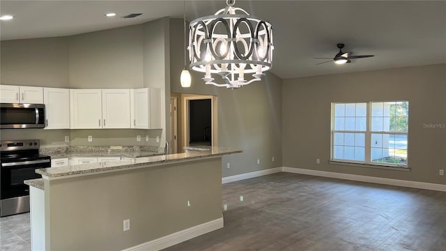 kitchen featuring light stone counters, stainless steel appliances, baseboards, open floor plan, and white cabinets