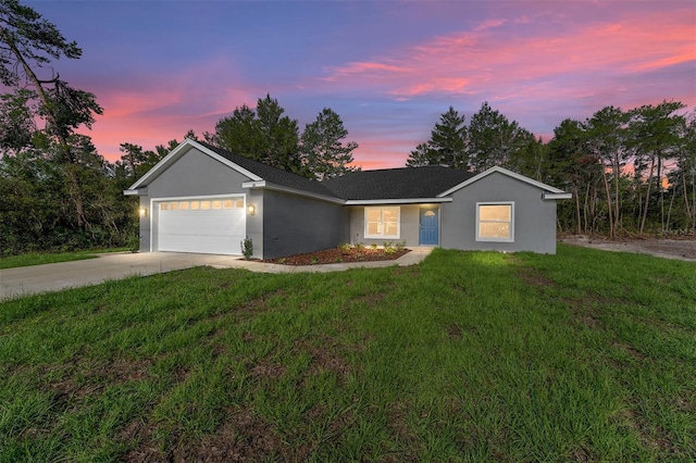 114 Bay Dr, Ocklawaha, FL 32179 - ranch-style home with an attached garage, a front lawn, concrete driveway, and stucco siding