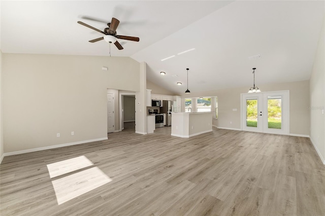 114 Bay Dr, Ocklawaha, FL 32179 - unfurnished living room featuring french doors, a ceiling fan, baseboards, light wood-style floors, and high vaulted ceiling