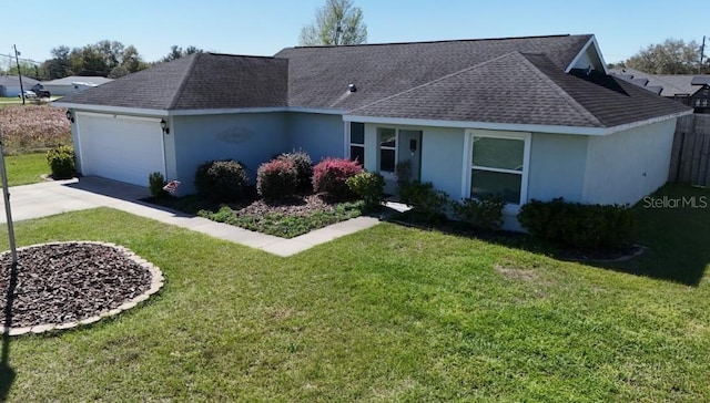 single story home featuring an attached garage, concrete driveway, roof with shingles, stucco siding, and a front lawn