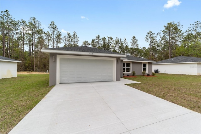 ranch-style house featuring a front yard, driveway, an attached garage, and stucco siding