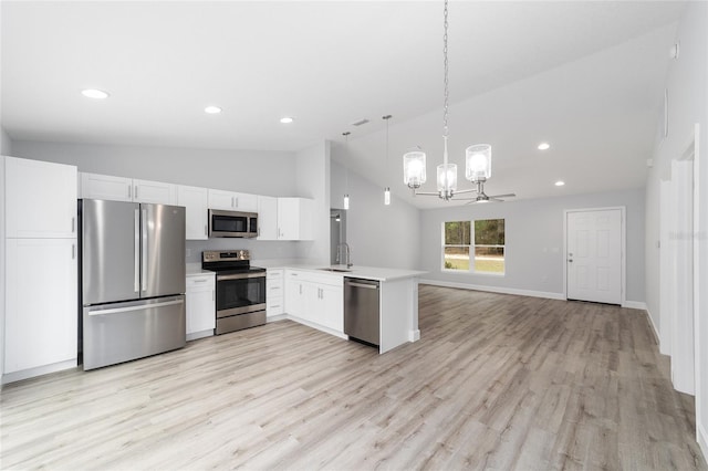 kitchen featuring white cabinets, open floor plan, light countertops, stainless steel appliances, and a sink