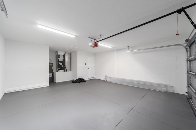 garage featuring a garage door opener, concrete block wall, and water heater