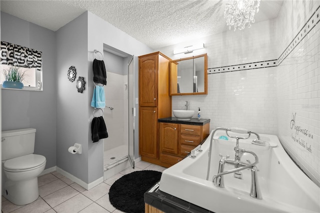 full bath featuring toilet, a textured ceiling, a bath, and tile patterned floors