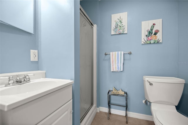 full bathroom featuring toilet, vanity, baseboards, tile patterned floors, and a stall shower