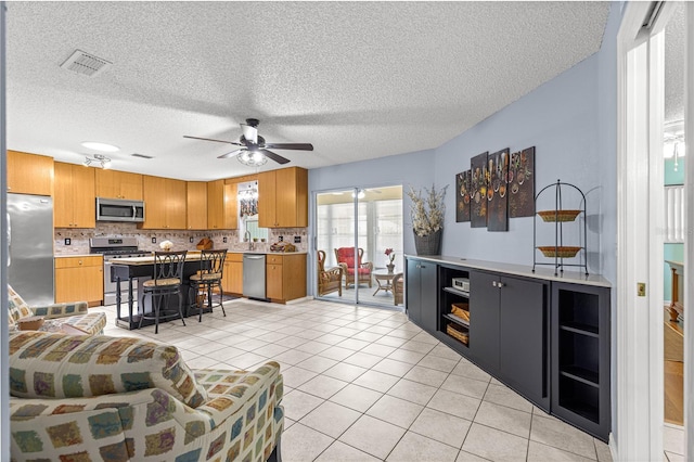 9770 SW 97th Pl, Ocala, FL 34481 - living room featuring ceiling fan, light tile patterned floors, and a textured ceiling