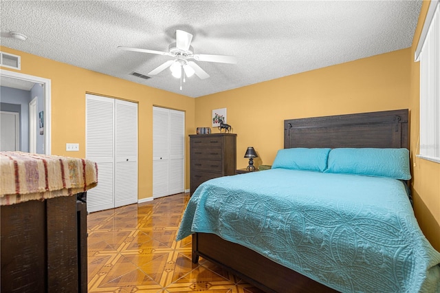 9770 SW 97th Pl, Ocala, FL 34481 - bedroom featuring multiple closets, a textured ceiling, a ceiling fan, and tile patterned floors