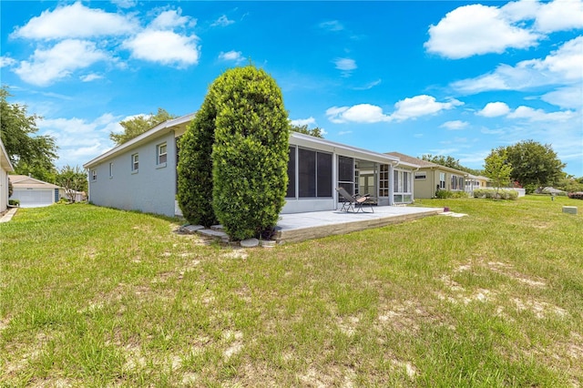 9770 SW 97th Pl, Ocala, FL 34481 - back of property featuring a patio, a yard, and a sunroom