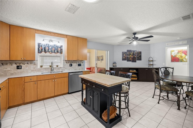 9770 SW 97th Pl, Ocala, FL 34481 - kitchen with dishwasher, a sink, backsplash, a ceiling fan, and light tile patterned floors
