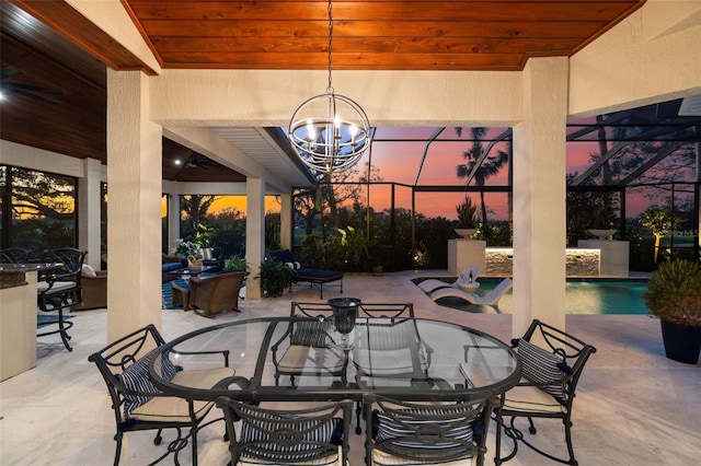 patio terrace at dusk with outdoor dining area, a lanai, and an outdoor pool