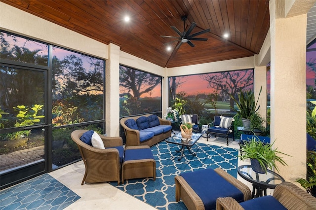 sunroom featuring a ceiling fan, wooden ceiling, and vaulted ceiling