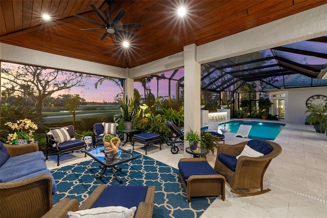 view of patio featuring an outdoor hangout area, glass enclosure, ceiling fan, and an outdoor pool