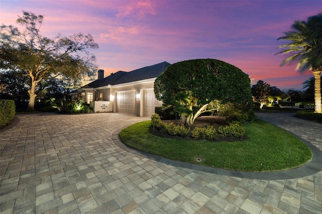 view of front of home featuring a garage and decorative driveway