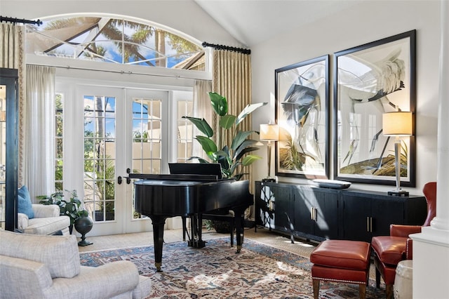 sitting room with lofted ceiling, a wealth of natural light, and french doors