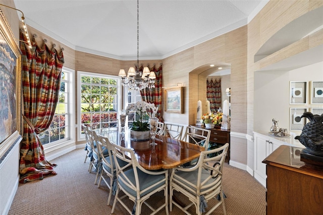 dining area with light carpet, baseboards, and a notable chandelier